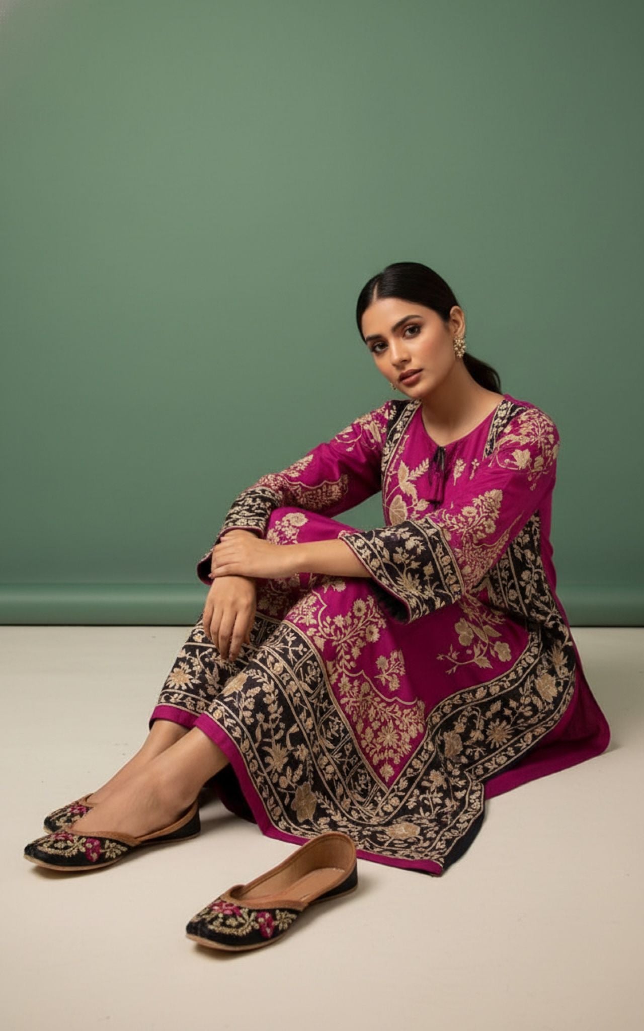 Luxury embroidered South Asian women's outfits with intricate handwork and gold detailing