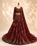 Ruby Bridal Lehenga 3-Piece Set in deep red with multicoloured embroidery and a scalloped teal border, shown on a mannequin with the matching dupatta draped at the shoulder
