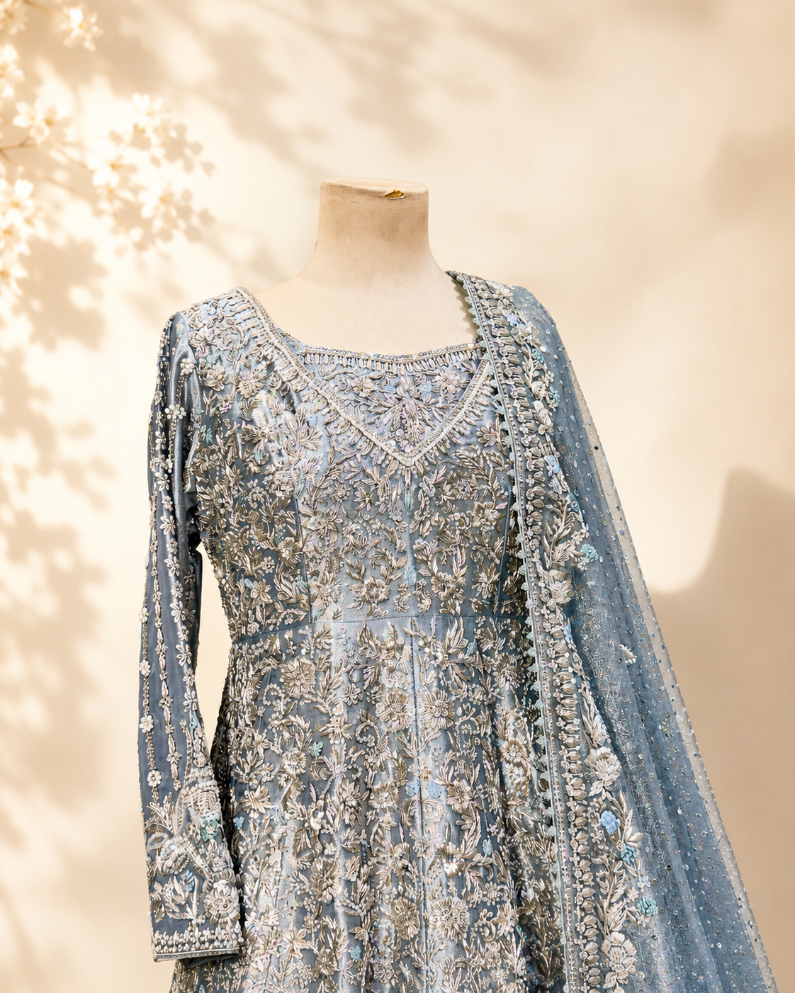 Close detail of the Sapphire bridal anarkali bodice and neckline, showing dense silver and antique-gold floral embroidery with a jewelled neckline