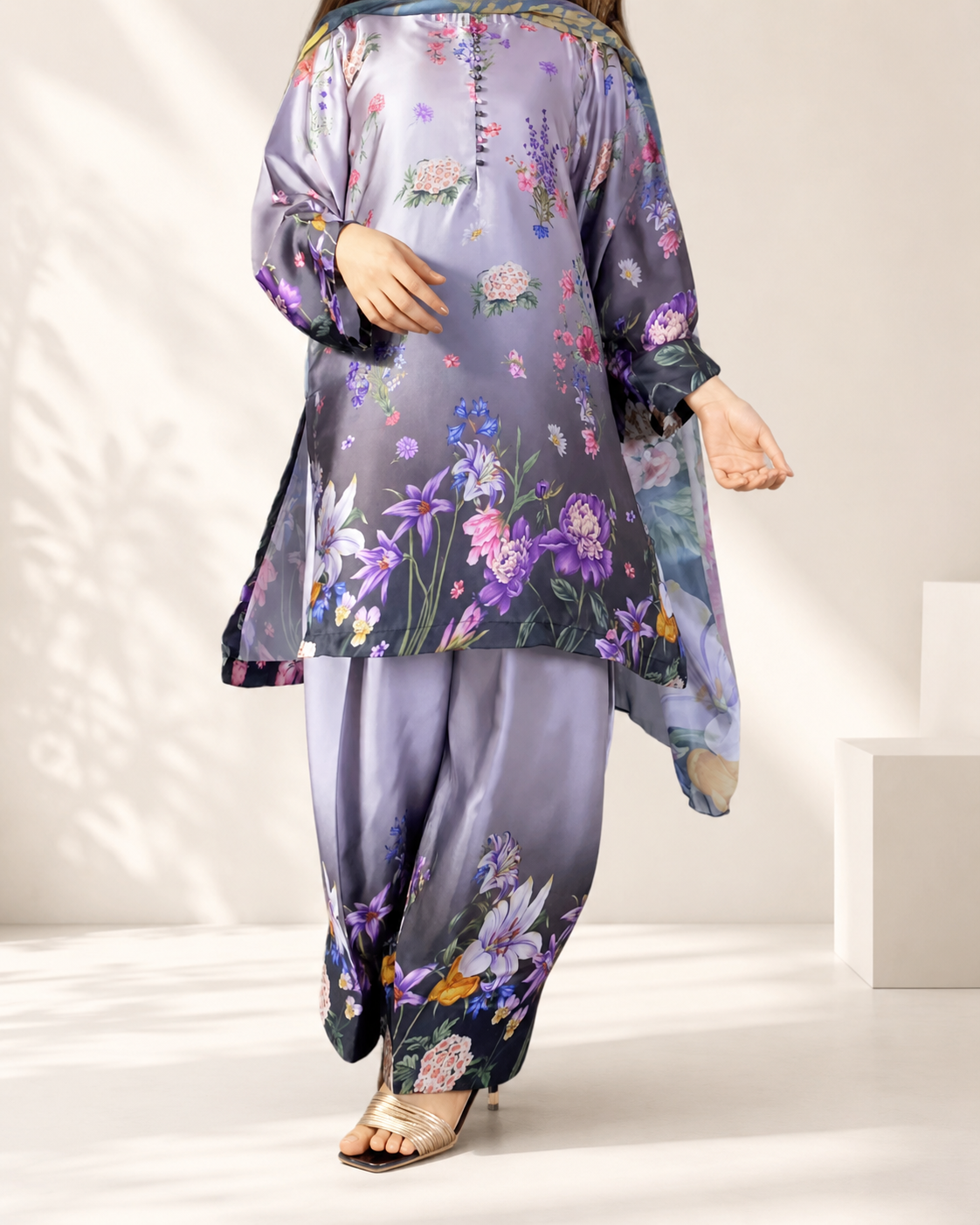 Close-up of the lilac floral print and pearl-button placket on the kameez