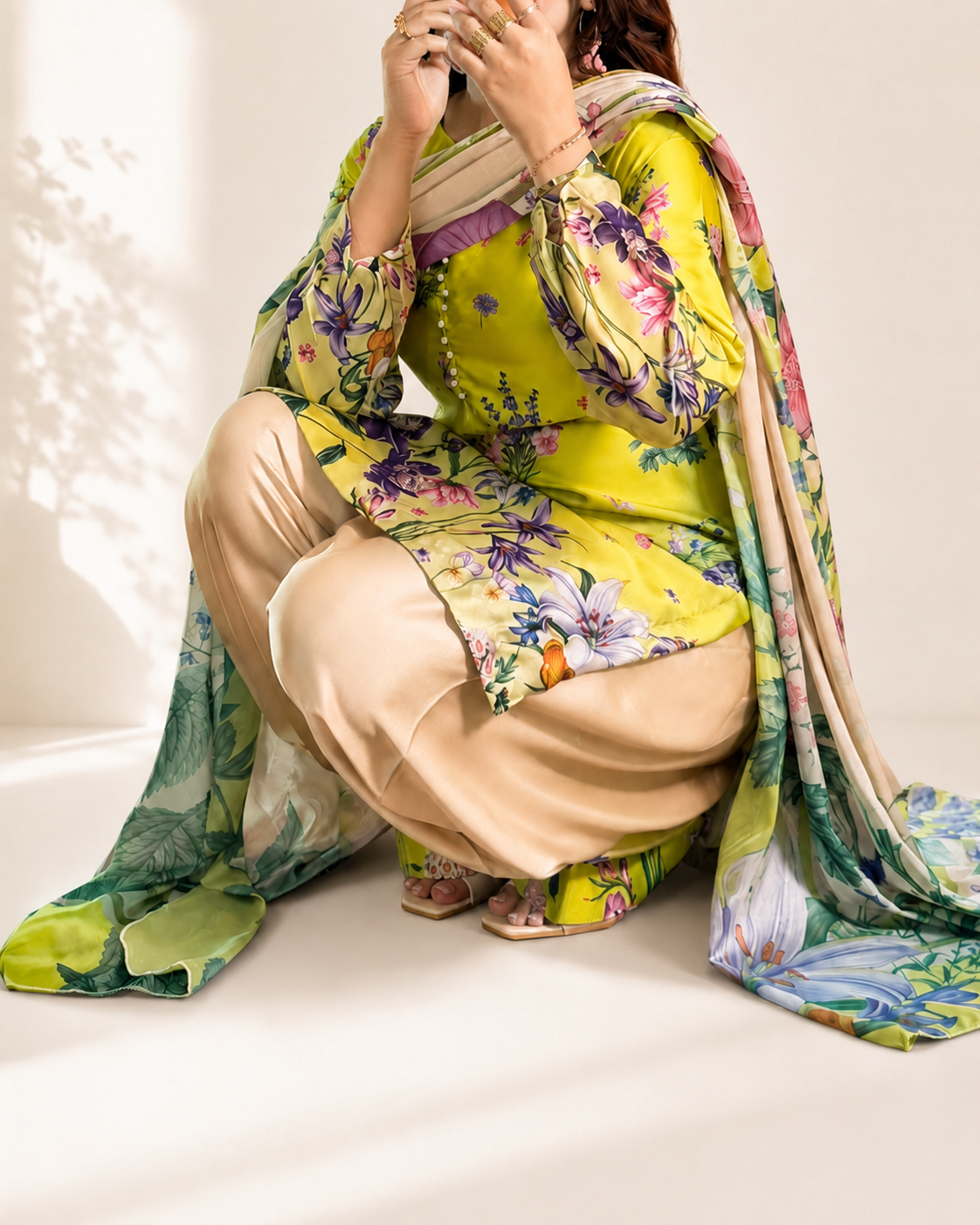 Model wearing the lime floral three-piece suit, seated styling
